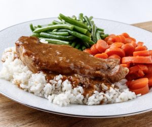 THURSDAY: SMOTHERED PORK CHOPS OVER RICE,and your choice of two sides: GLAZED CARROTS, GREEN BEANS, OR MACARONI & CHEESE